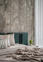 Modern living room with a green sofa, decorative pillows, and a side table against a marble wall.